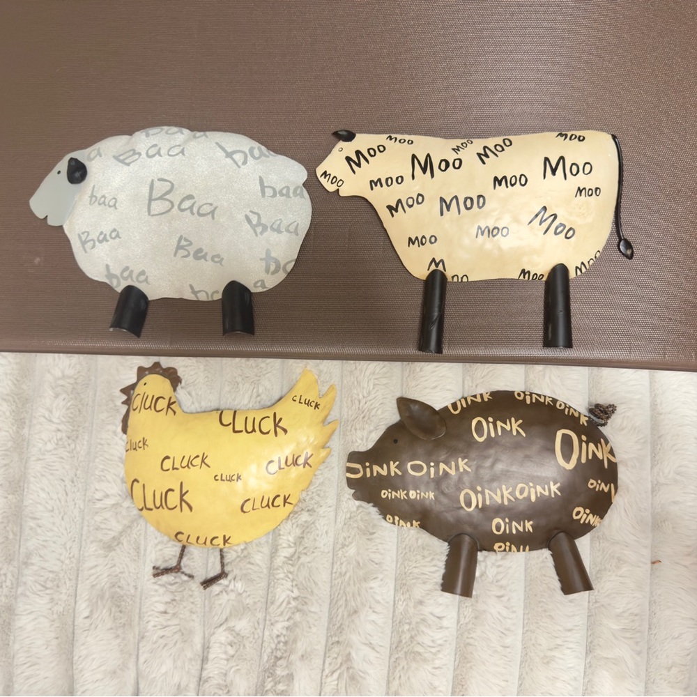 Set of four metal farm animal figures, a sheep, cow, chicken, and pig,